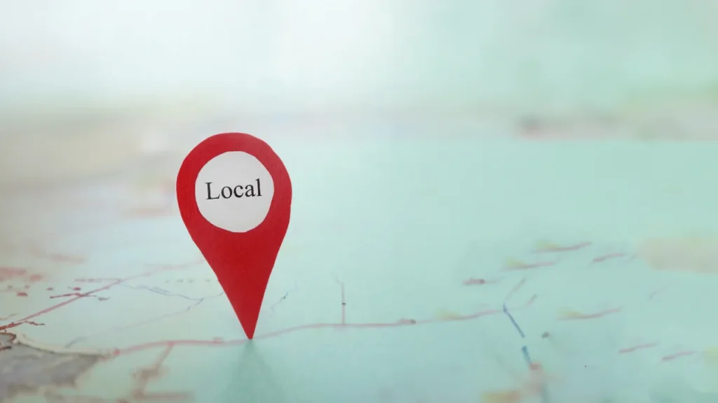 A map pin labeled "Local" prominently placed on a blurry map background, symbolizing a focus on local business presence.